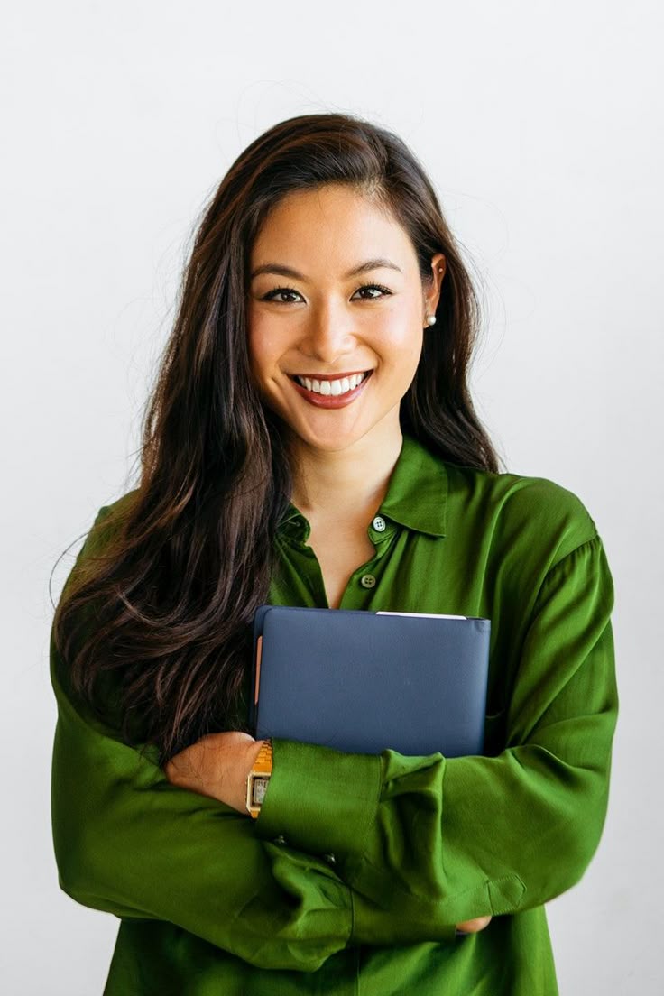 woman in green shirt holiding blue file